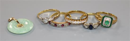 Five assorted 18ct gold and gem set rings including ruby and diamond half hoop and emerald and enamel and a jadeite pendant.